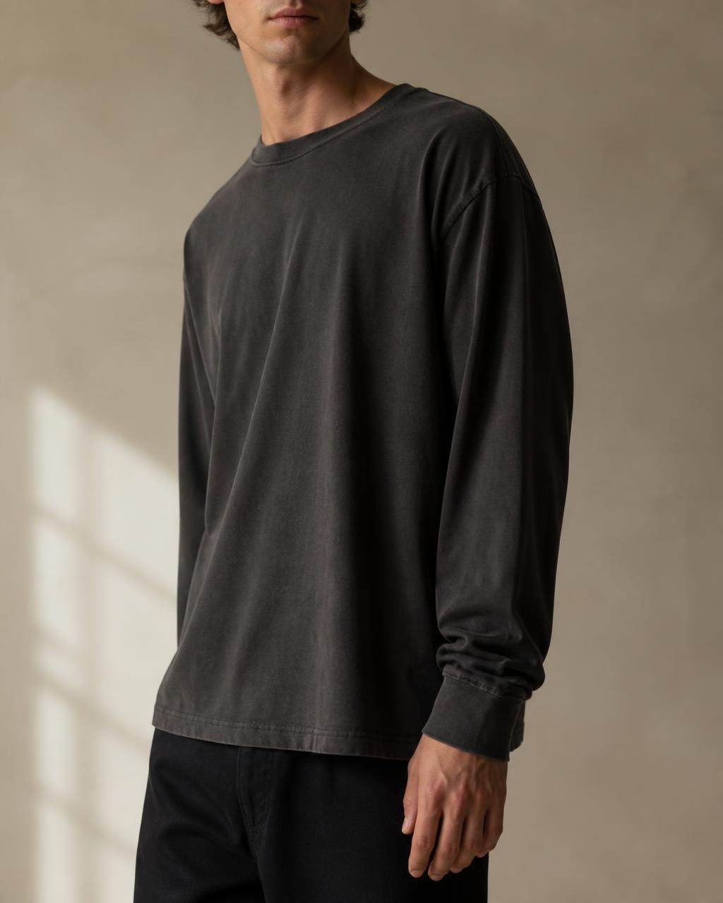 Model wearing a washed charcoal long sleeve tee — “God's in control”
